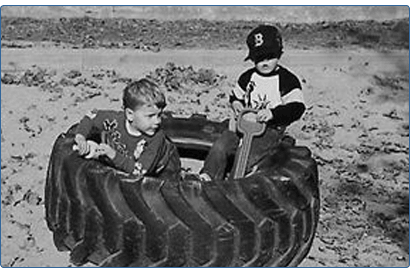 kids playing in a giant truck tire